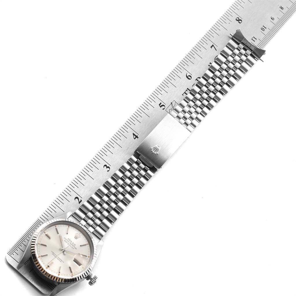 The image shows a Rolex Vintage Collection 16014 Men's Stainless Steel Silver Dial 16014 Men's Stainless Steel Silver Dial watch laid flat, emphasizing its face, bracelet, and clasp against a ruler for scale.