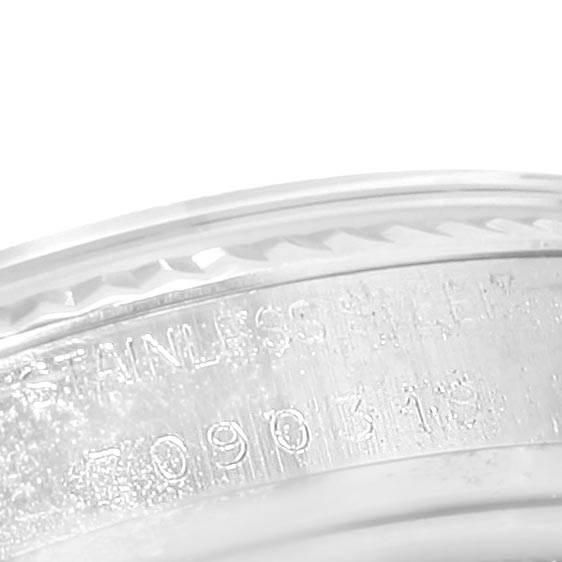 This close-up image shows the engraved serial number and part of the bezel of a Rolex Vintage Collection 16014 Men's Stainless Steel Black Dial 16014 Men's Stainless Steel Black Dial model.