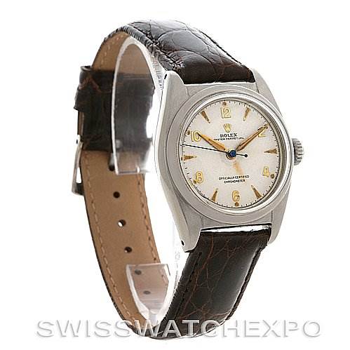 The image shows a Vintage Collection Rolex watch from a front-left angle, highlighting the face, bezel, and leather strap.