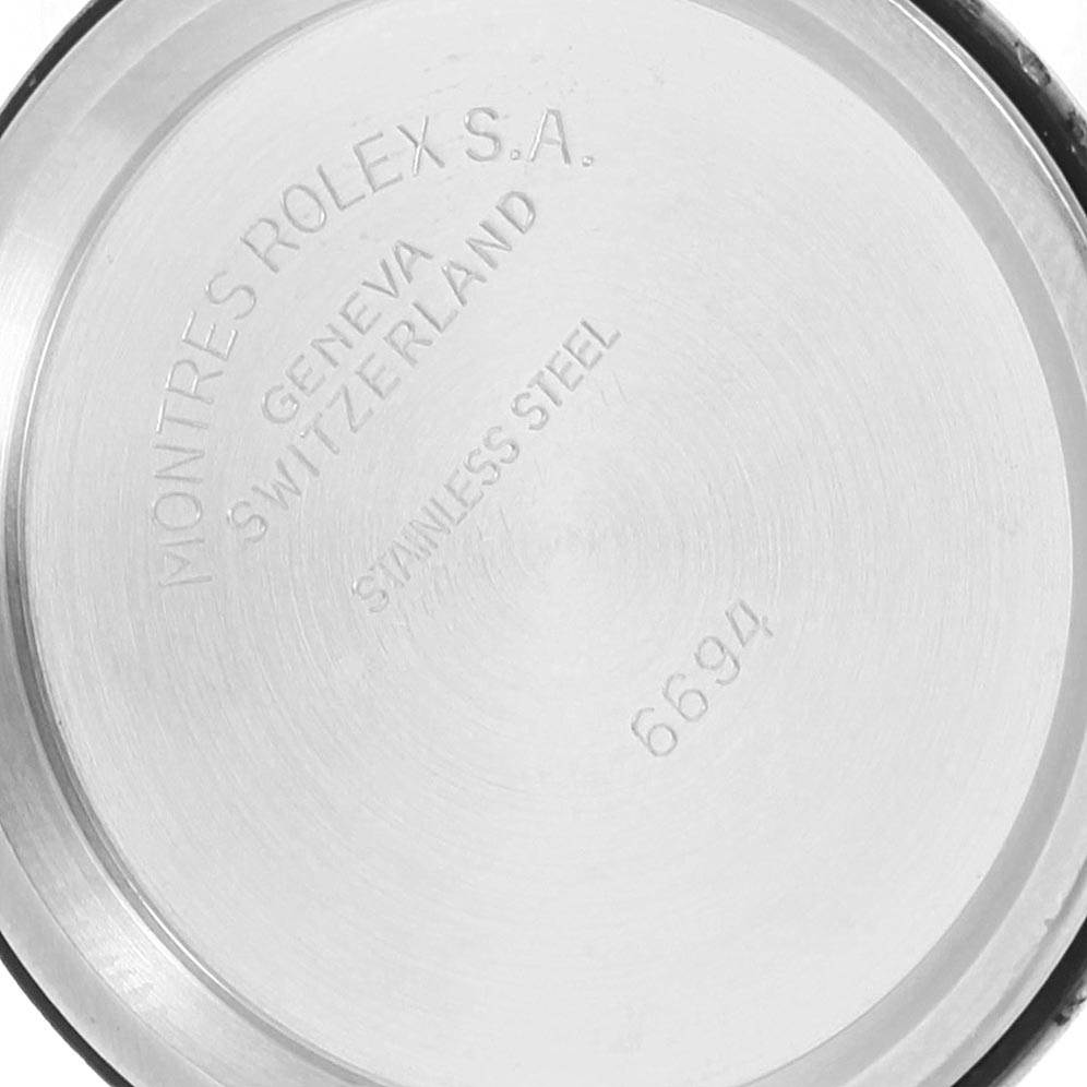 The image shows the back case of a Rolex Vintage Collection 6694 Men's Stainless Steel Black Dial 6694 Men's Stainless Steel Black Dial watch, displaying inscriptions and the model number 6694.