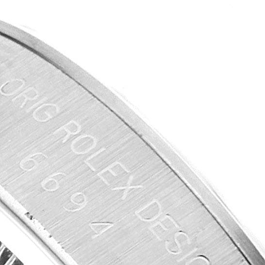 The image shows a close-up of the engraved writing on the side of the Rolex Vintage Collection 6694 Men's Stainless Steel Black Dial 6694 Men's Stainless Steel Black Dial watch case.