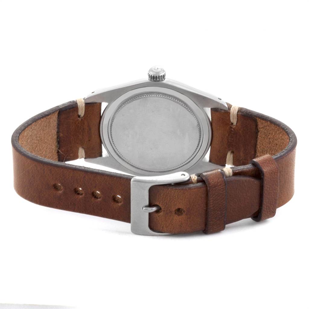 The image shows the back view of a Vintage Collection Rolex watch, highlighting its case and leather strap with buckle.