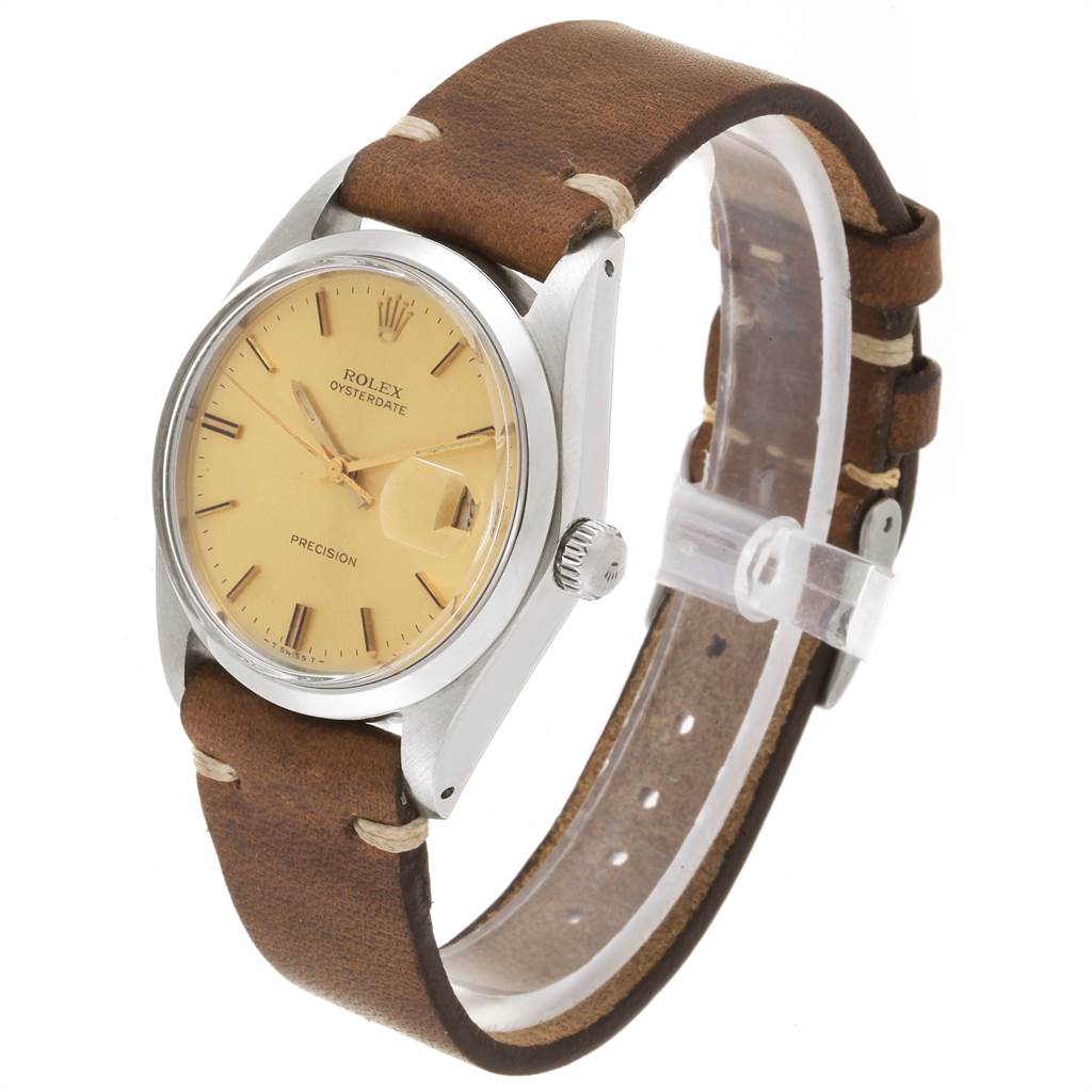 The Vintage Collection Rolex watch is shown at a slight angle, highlighting its brown leather strap, beige dial, and crown.