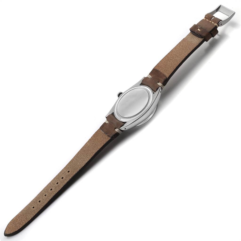 This is an overhead view of a Rolex Vintage Collection 6694 Men's Stainless Steel Champagne Dial 6694 Men's Stainless Steel Champagne Dial watch, showing its brown leather strap and case back.