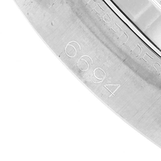 This image shows a close-up of the case with engraving on a Rolex Vintage Collection 6694 Men's Stainless Steel Champagne Dial 6694 Men's Stainless Steel Champagne Dial model watch, including the number "6694".