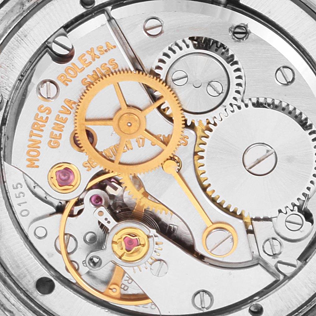 This image shows the internal mechanical parts of a Vintage Collection model watch by Rolex, highlighting gears and engravings.