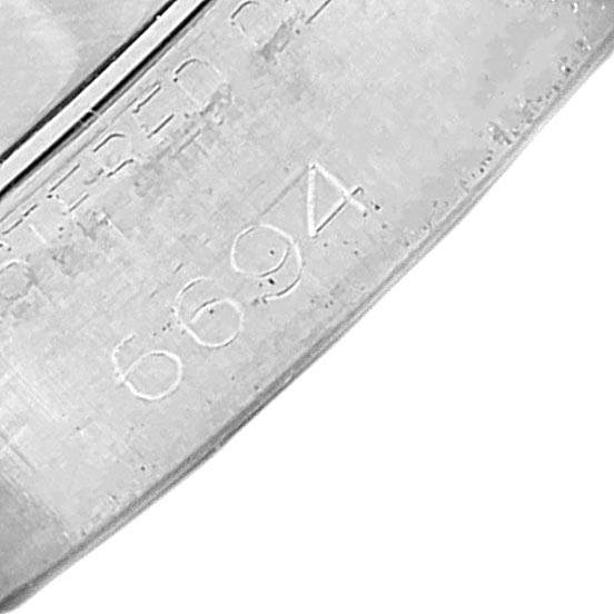 Close-up of the inner case of a Vintage Collection Rolex model, showing the number 6694 engraved.