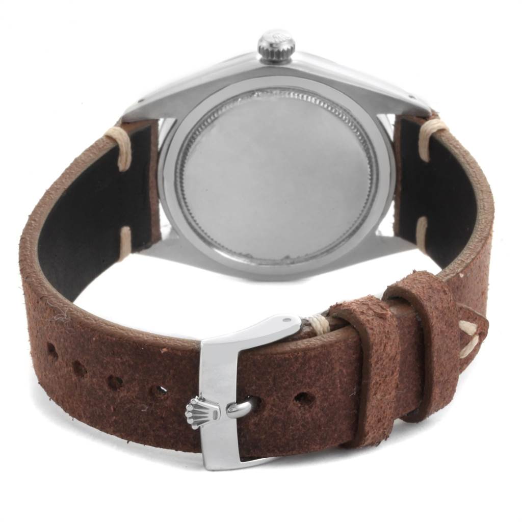 The image shows the back view of a Rolex Vintage Collection 6694 Men's Stainless Steel Silver Dial 6694 Men's Stainless Steel Silver Dial watch with a brown leather strap and metal clasp.
