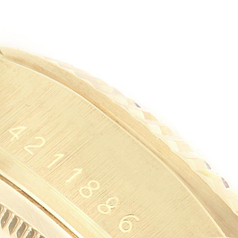 The image shows a close-up of the side of a Rolex Vintage Collection 1803 Men
s Yellow Gold Champagne Dial 1803 Men
s Yellow Gold Champagne Dial watch, highlighting the serial number engraving on its case.
