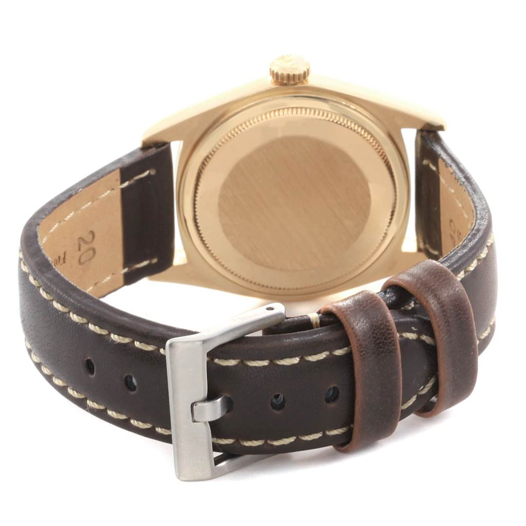 The image shows the back case and leather strap of the Rolex Vintage Collection 1803 Men
s Yellow Gold Champagne Dial 1803 Men
s Yellow Gold Champagne Dial watch from a rear angle.