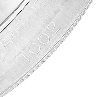 This close-up image shows the outer edge and part of the casing of the Rolex Vintage Collection 1002 Men's Stainless Steel Blue Dial 1002 Men's Stainless Steel Blue Dial model, highlighting the engraved serial number "1002."