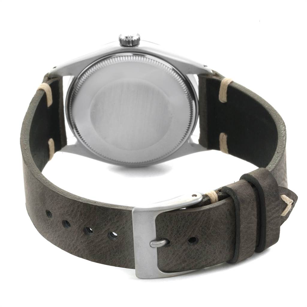 This image shows the back view of a Vintage Collection model by Rolex, including the case back and leather strap with buckle.