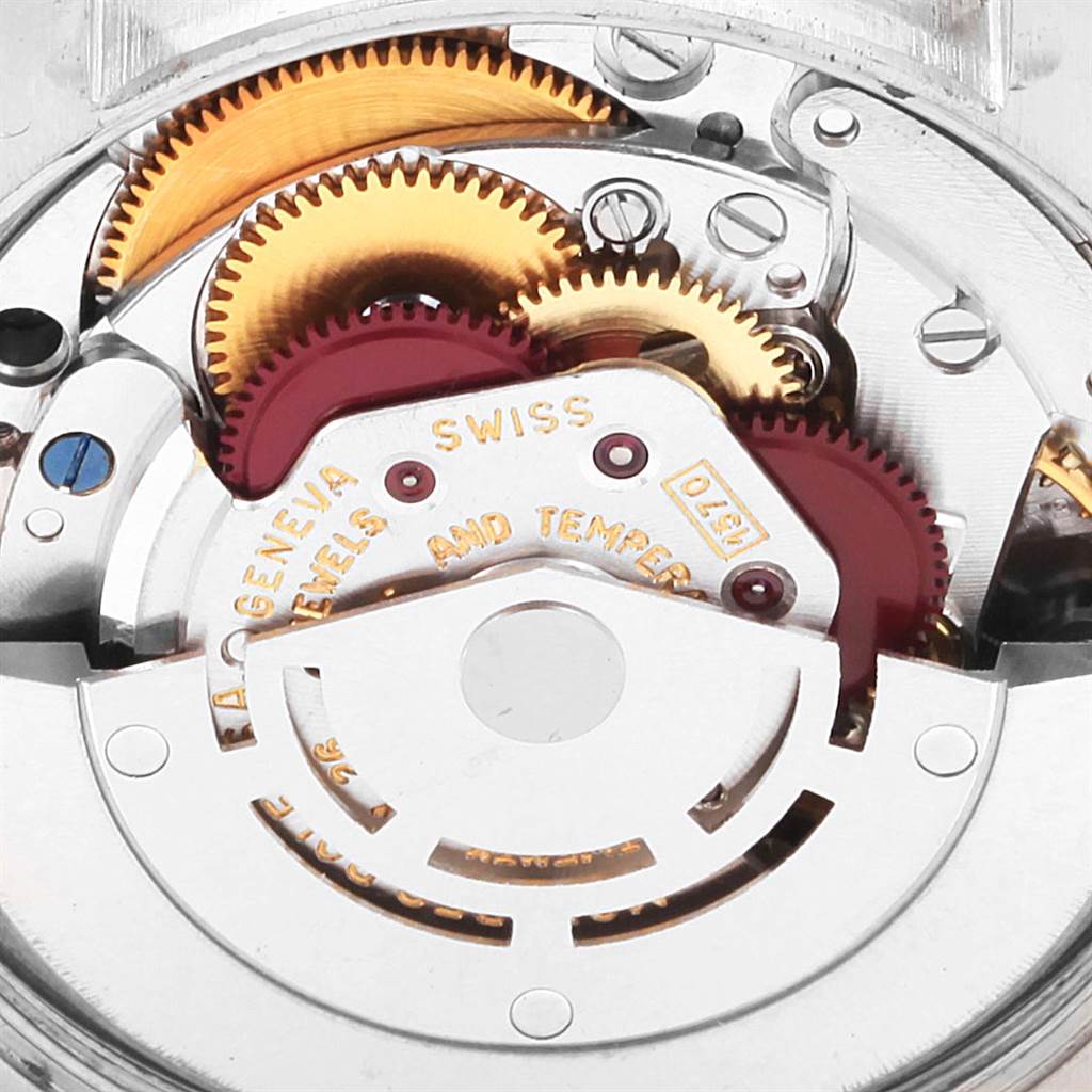 The image shows a close-up of the internal mechanism of the Rolex Vintage Collection 1002 Men's Stainless Steel Blue Dial 1002 Men's Stainless Steel Blue Dial watch, highlighting gears and movement parts.