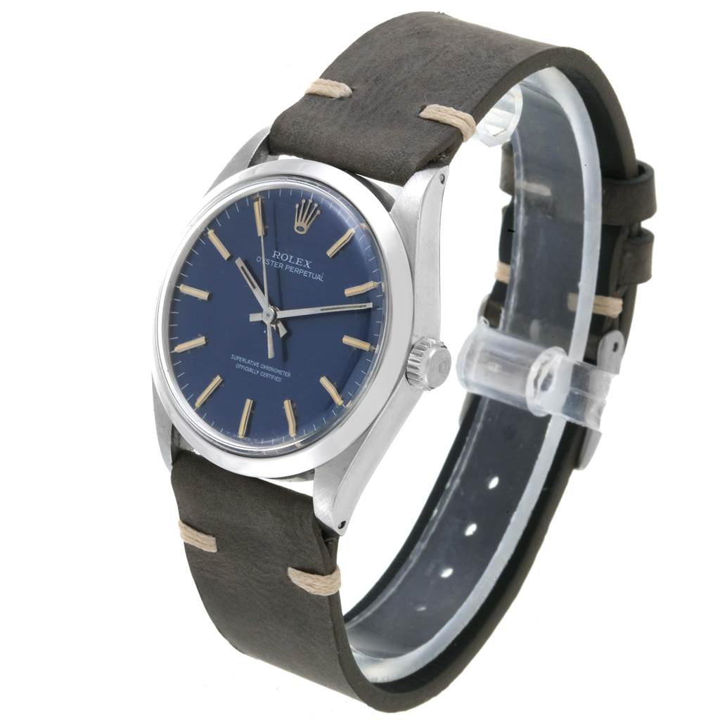 This image shows a side angle of a Vintage Collection Rolex Oyster Perpetual watch with a blue dial and leather strap.