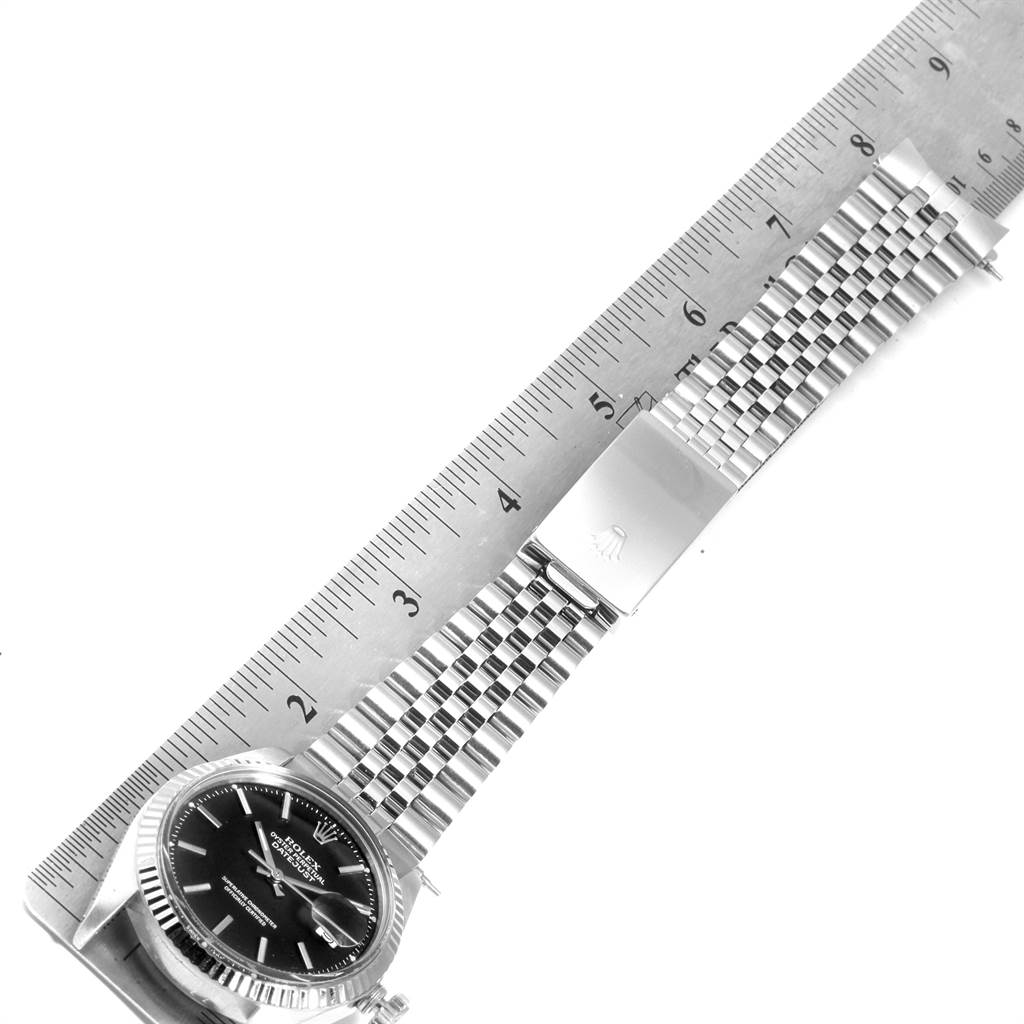 The image shows the face and metal bracelet of the Rolex Vintage Collection 1601 Men's Stainless Steel Black Dial 1601 Men's Stainless Steel Black Dial watch, measured against a ruler.
