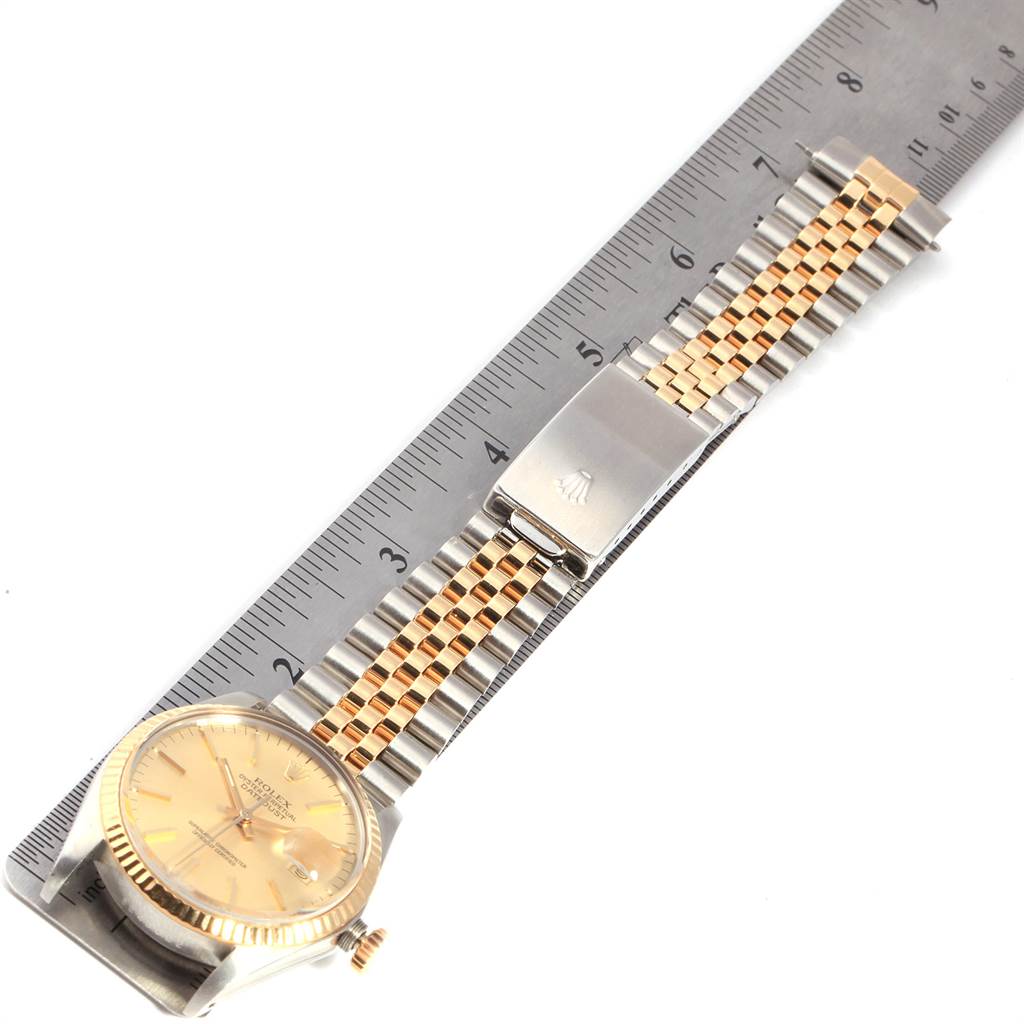 The image shows a Rolex Vintage Collection 16013 Men's Stainless Steel Champagne Dial 16013 Men's Stainless Steel Champagne Dial watch laid flat, highlighting its face, band, and clasp next to a ruler for scale.