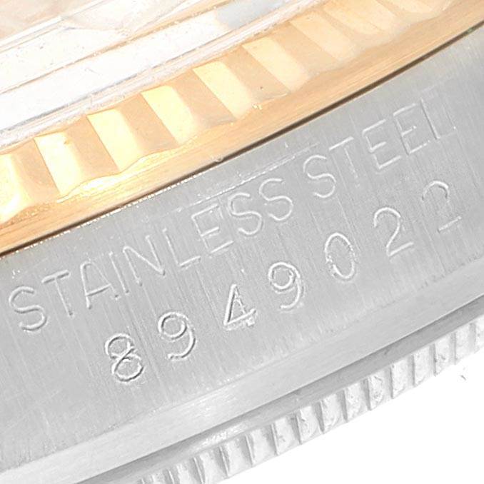 The image shows a close-up of the side of the Rolex Vintage Collection 16013 Men's Stainless Steel Champagne Dial 16013 Men's Stainless Steel Champagne Dial watch, highlighting the stainless steel material and serial number.