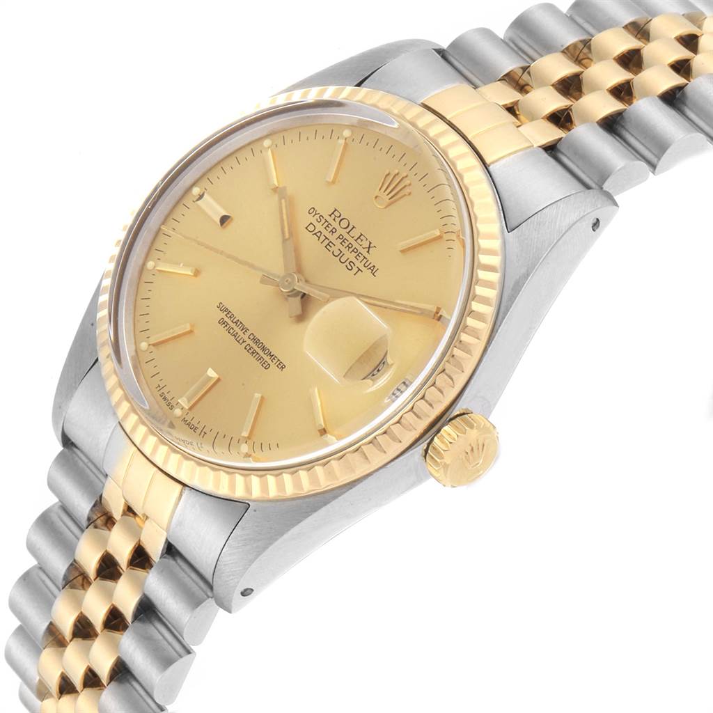 The image shows a Vintage Collection Rolex Datejust watch from a slight side angle, highlighting the gold bezel, dial, and a portion of the bracelet.