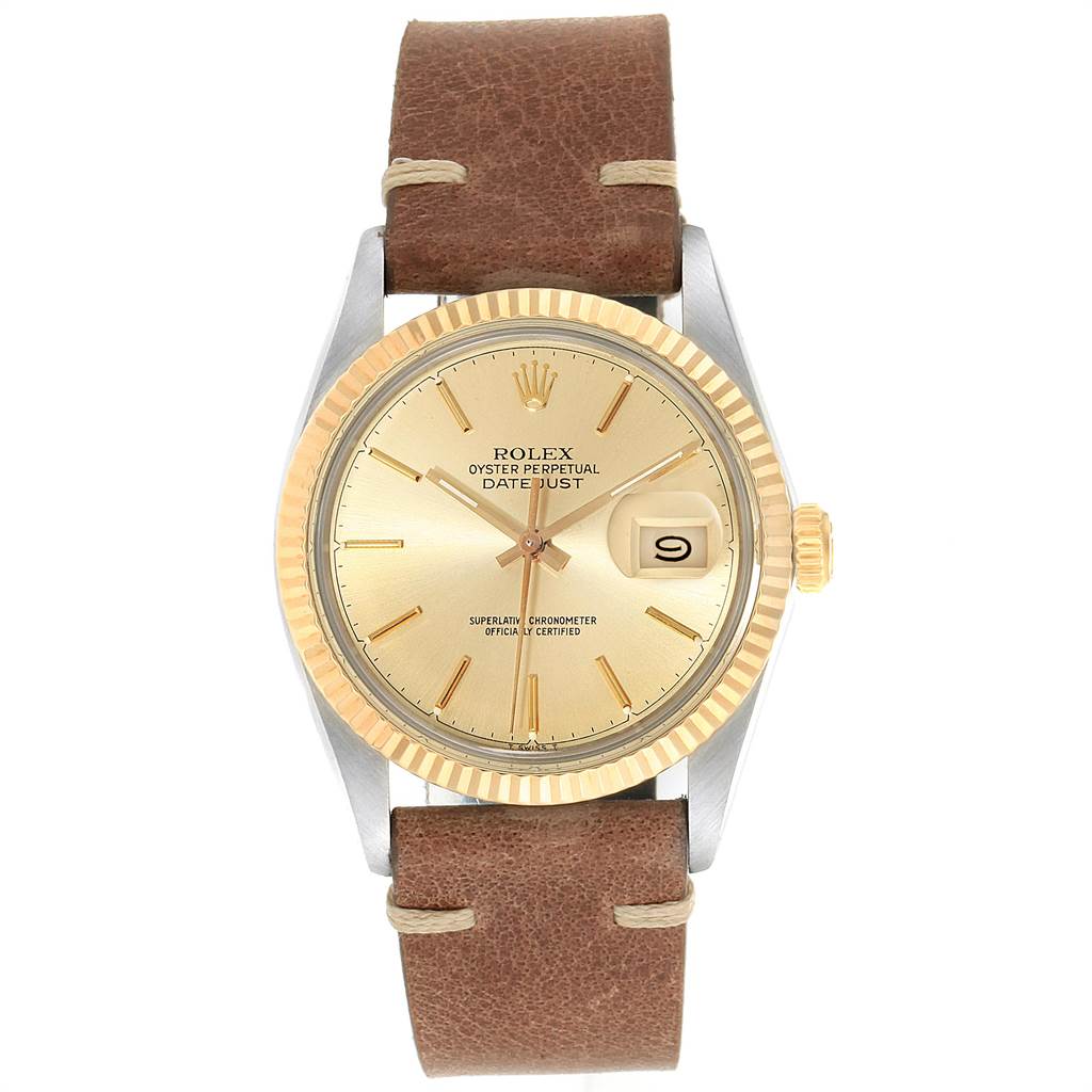 The Rolex Vintage Collection 16013 Men's Stainless Steel Champagne Dial 16013 Men's Stainless Steel Champagne Dial Datejust watch is shown from the front, featuring a gold dial, fluted bezel, and brown leather strap.