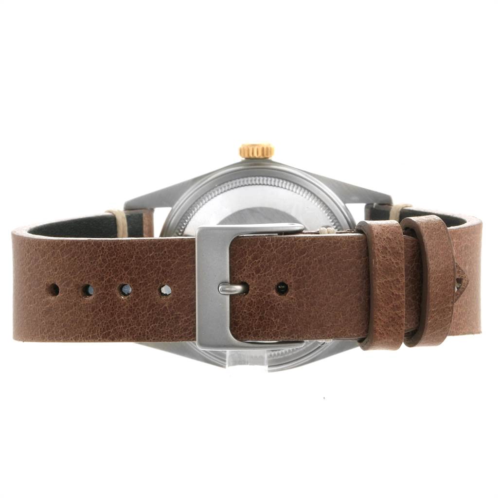 The Vintage Collection model by Rolex is shown from the back, highlighting the case and brown leather strap with a buckle.