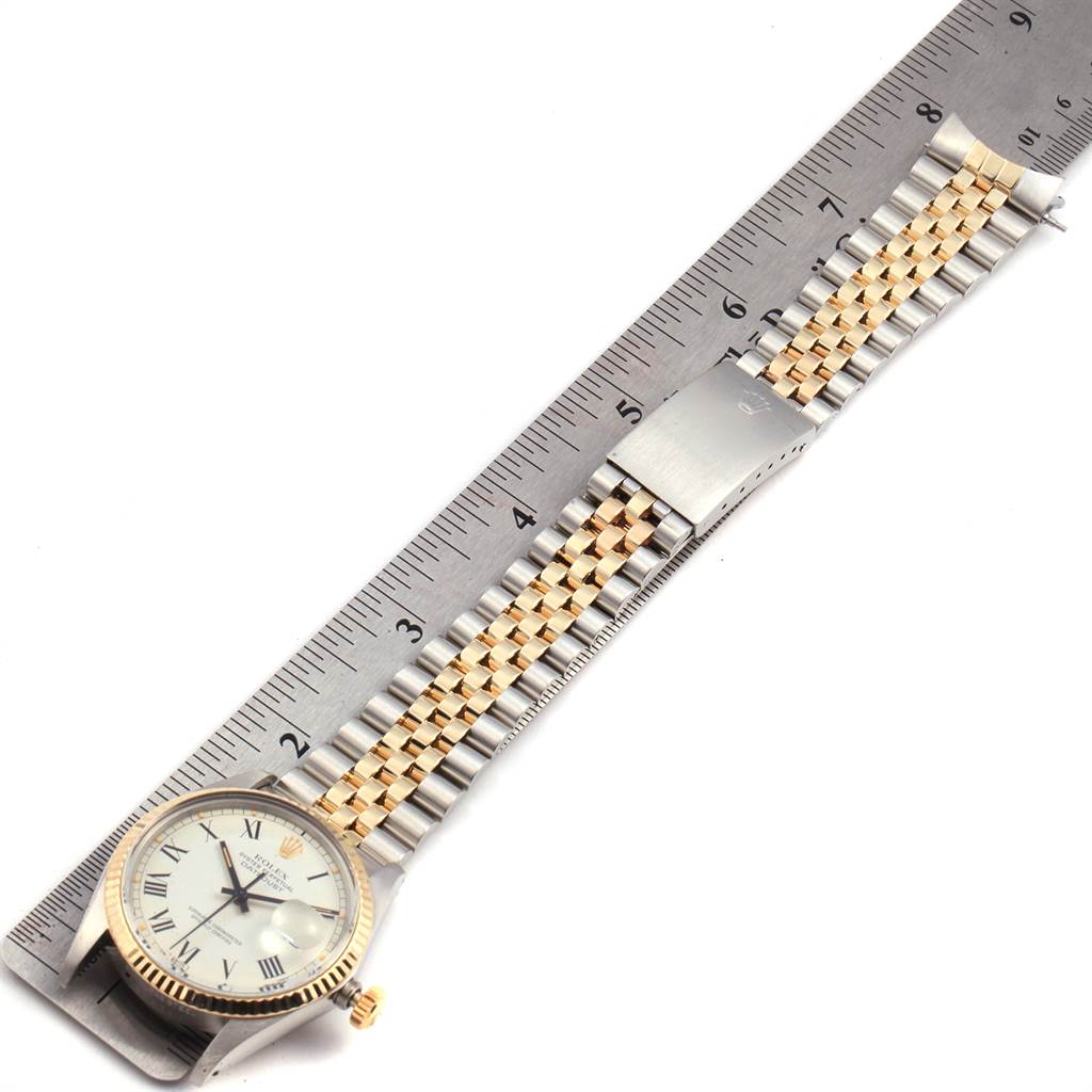 The image shows a Rolex Vintage Collection 16013 Men's Stainless Steel White Dial 16013 Men's Stainless Steel White Dial watch laid flat next to a ruler, emphasizing its band and face.