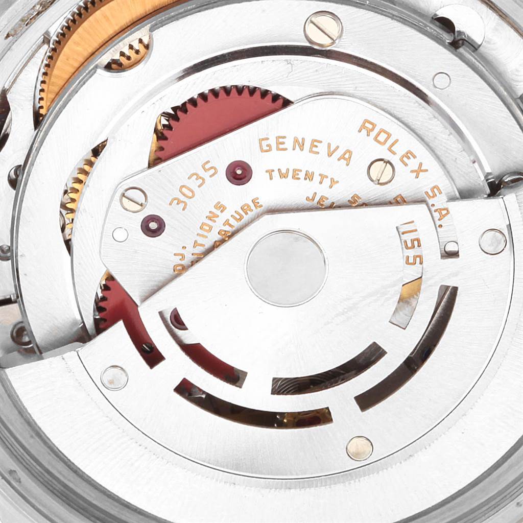 The image shows a close-up of the movement of the Vintage Collection Rolex watch, highlighting gears and inscriptions.
