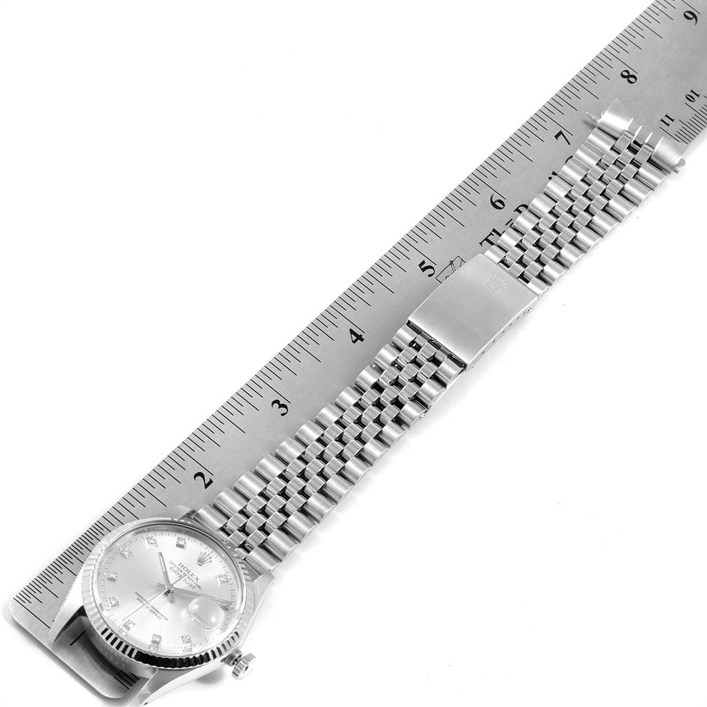 The image shows a Vintage Collection model by Rolex laid flat with a metal bracelet beside a ruler for measurement.