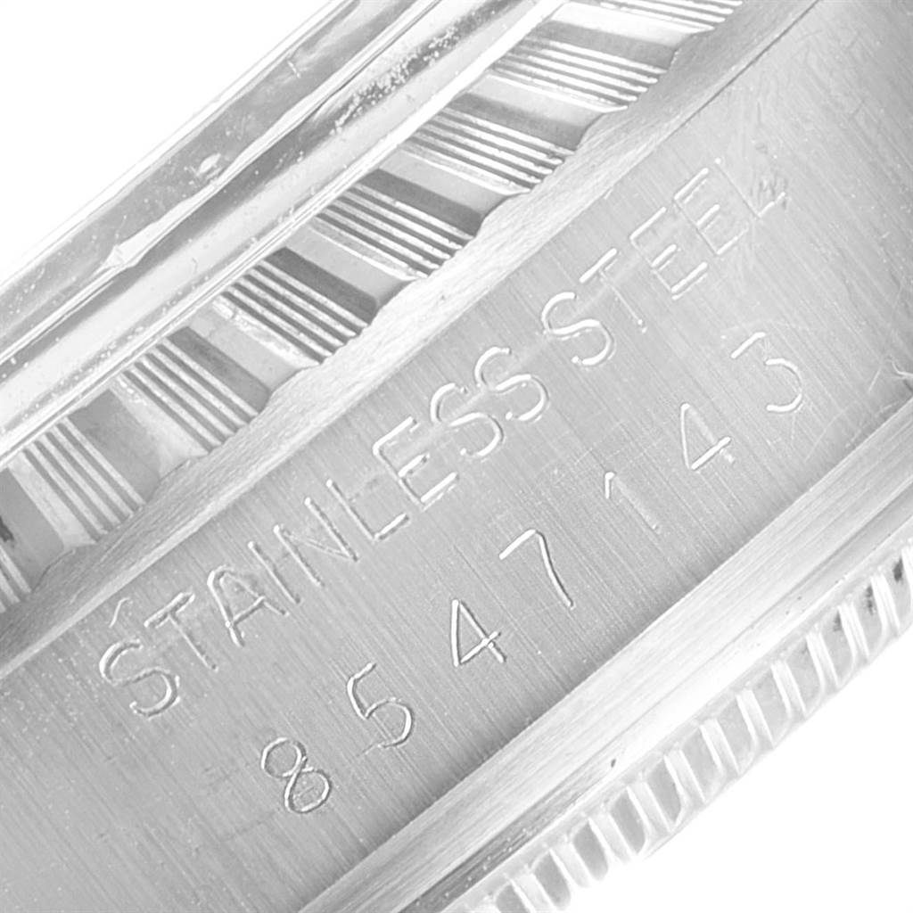 The image shows a close-up of the serial number and "STAINLESS STEEL" engraving on the case of a Vintage Collection model by Rolex.