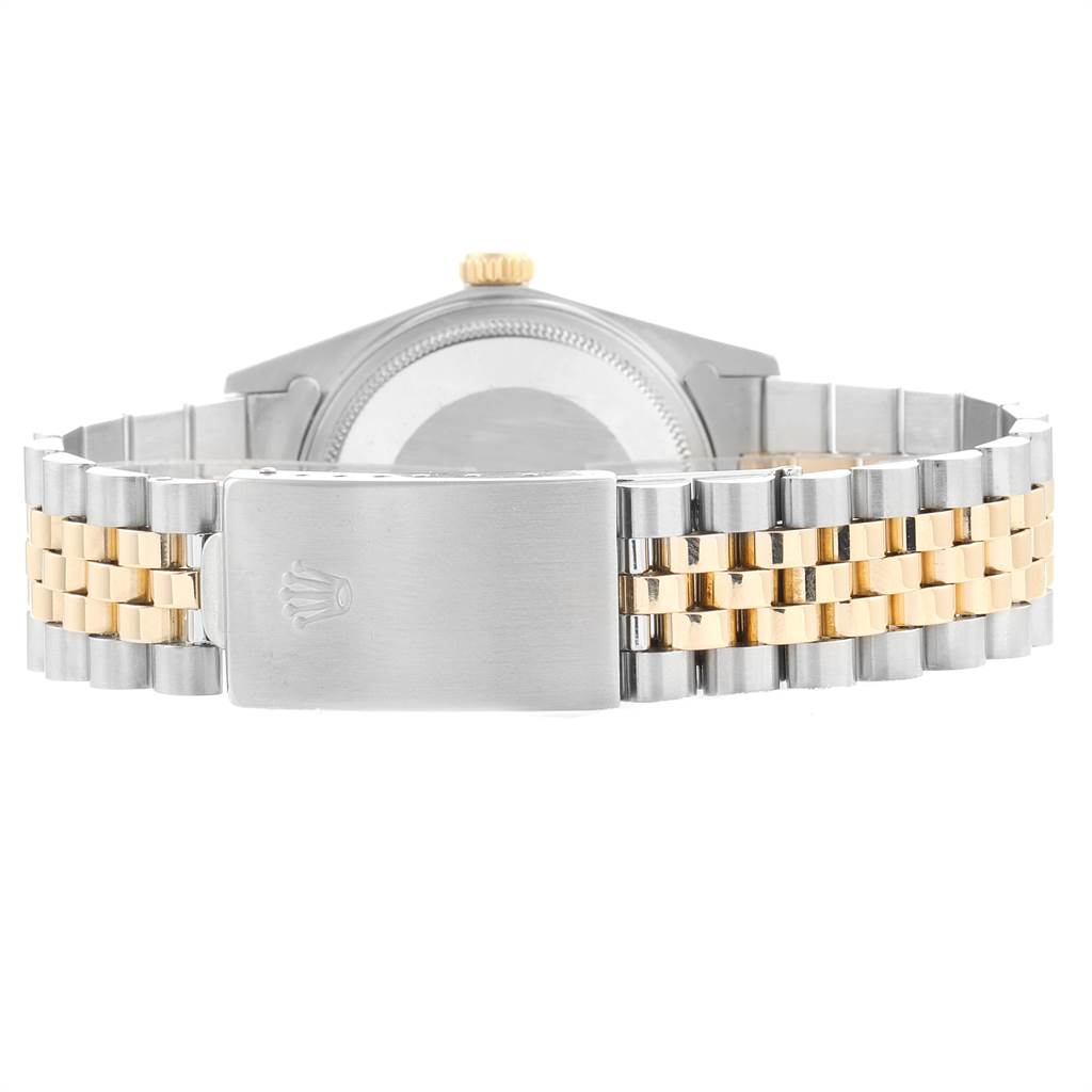 The image shows the backside of the Rolex Vintage Collection 16013 Men's Stainless Steel White Dial 16013 Men's Stainless Steel White Dial watch, highlighting its two-tone metal bracelet with a fold-over clasp.