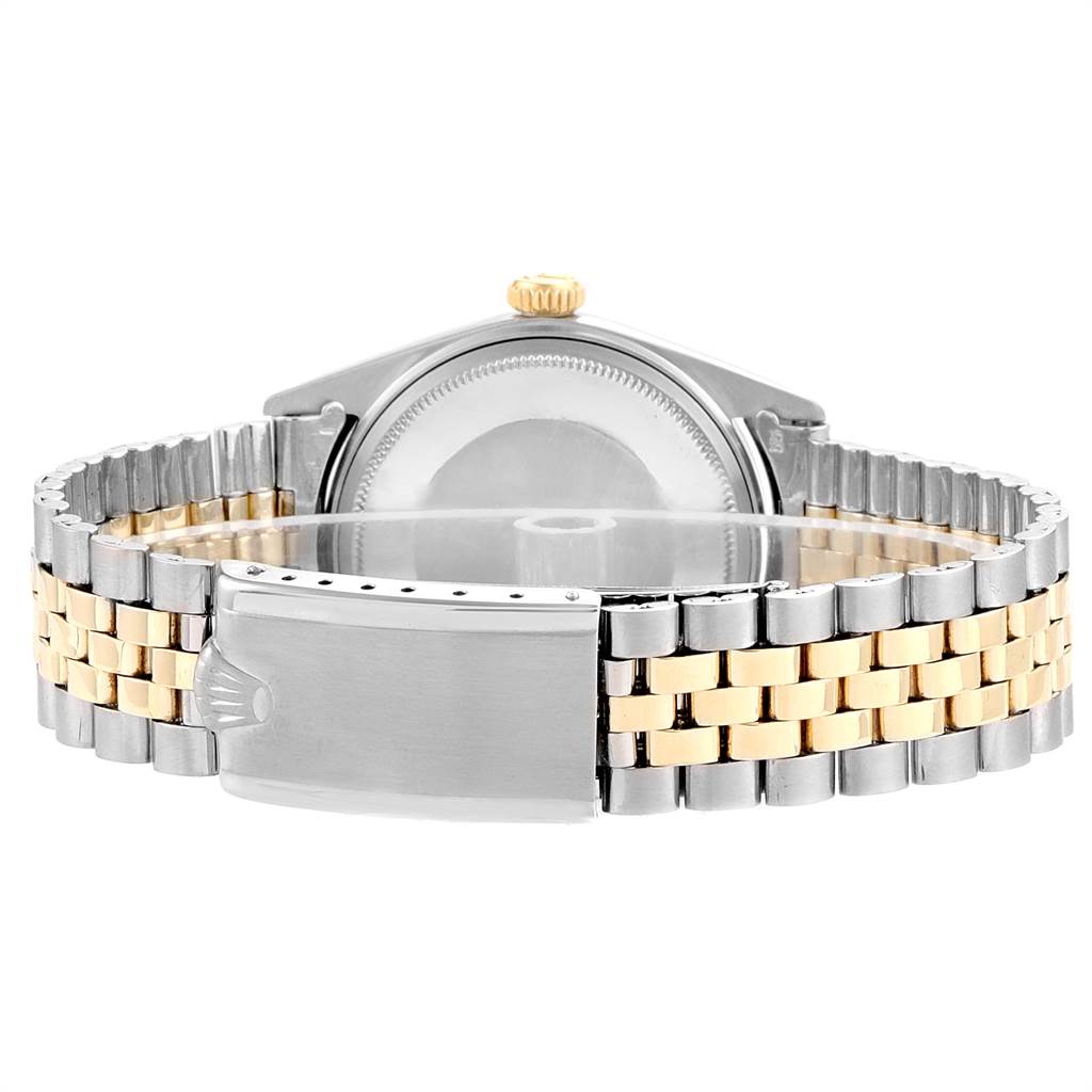 The image shows the back view of a Rolex Vintage Collection 1601 Men
s Steel and Gold (two tone) Champagne Dial 1601 Men
s Steel and Gold (two tone) Champagne Dial watch, highlighting its two-tone bracelet and clasp.