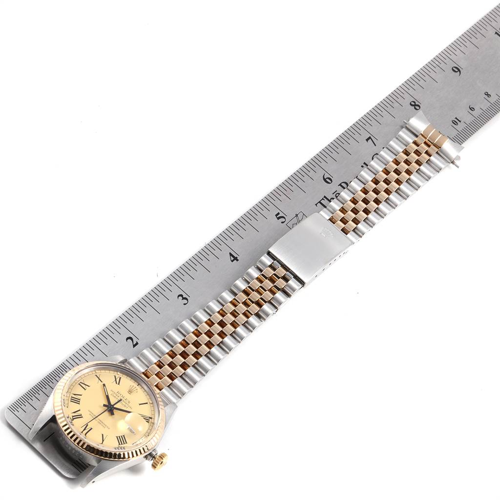 The Rolex Vintage Collection 16013 Men's Stainless Steel Champagne Dial 16013 Men's Stainless Steel Champagne Dial model watch is shown flat next to a ruler, highlighting its band and face.