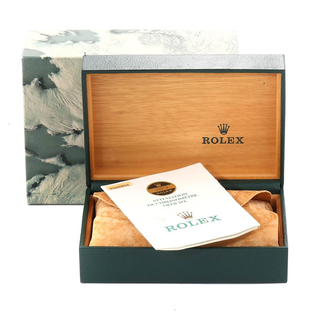 The image shows an open box with the Rolex Vintage Collection 16013 Men's Stainless Steel Champagne Dial 16013 Men's Stainless Steel Champagne Dial logo, containing a booklet and a watch cushion.