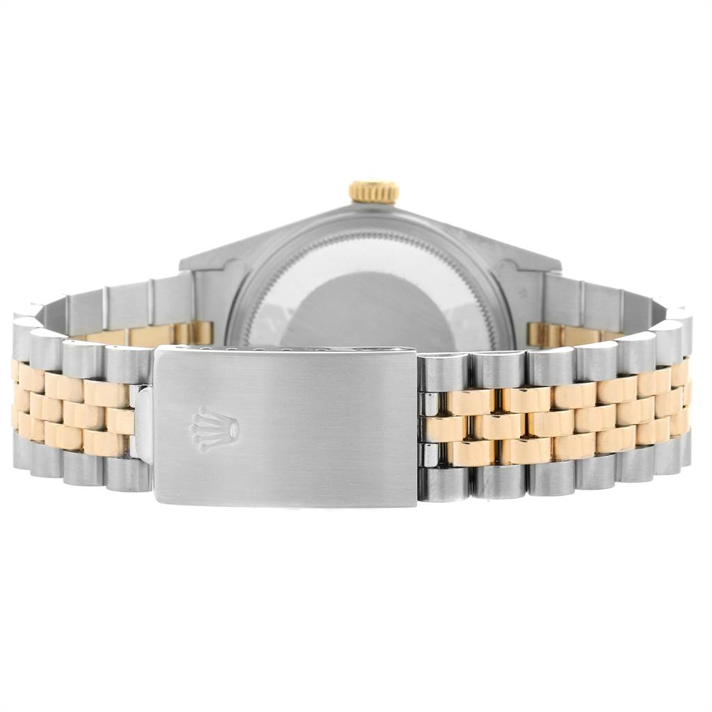 The image shows the back of the Rolex Vintage Collection 16013 Men's Stainless Steel Champagne Dial 16013 Men's Stainless Steel Champagne Dial watch and its two-tone metal bracelet.