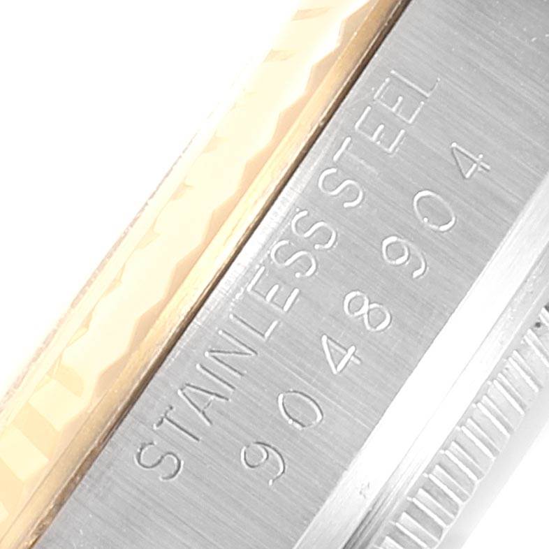 This image shows a close-up of the side of a Vintage Collection model by Rolex, highlighting the stainless steel and some identification numbers.