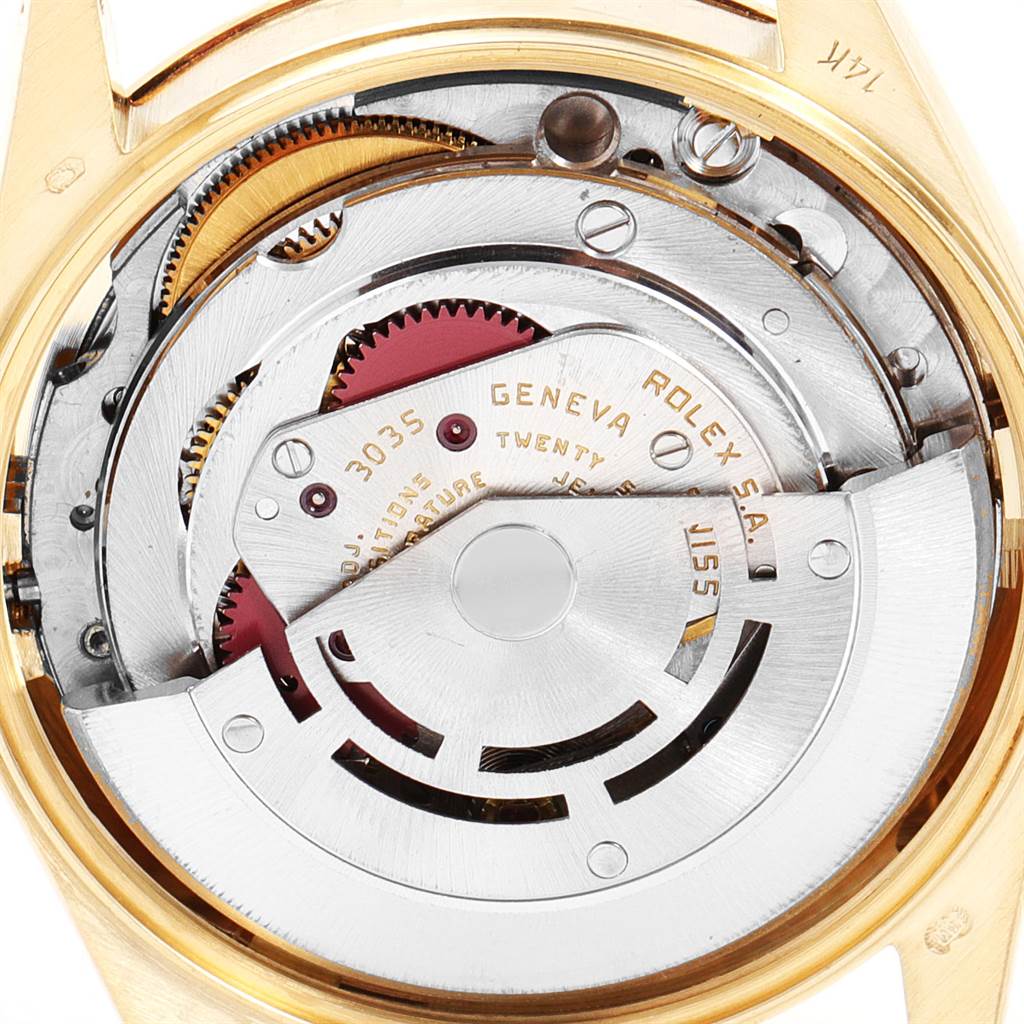 The image shows the internal movement of a Vintage Collection model by Rolex, focusing on the intricate gears and mechanism.