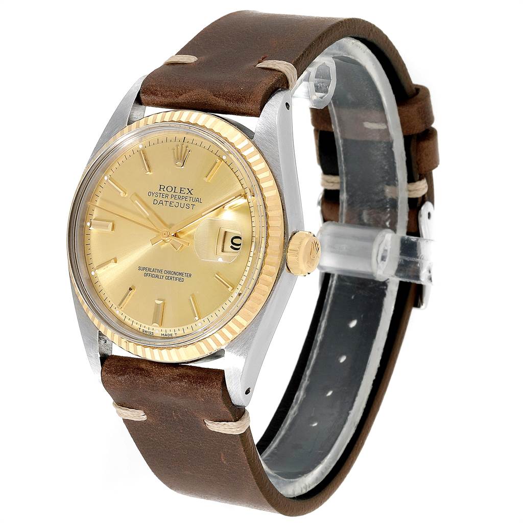 The Rolex Vintage Collection 1601 Men's Steel and Gold (two tone) Champagne Dial 1601 Men's Steel and Gold (two tone) Champagne Dial watch is shown at a three-quarter angle, featuring its gold dial, bezel, and brown leather strap.