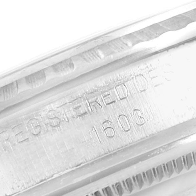 This image shows a close-up of the engraved bezel and part of the case of a Rolex Vintage Collection 1603 Men's Stainless Steel Brown Dial 1603 Men's Stainless Steel Brown Dial model, displaying "REGISTERED DESIGN 1603."