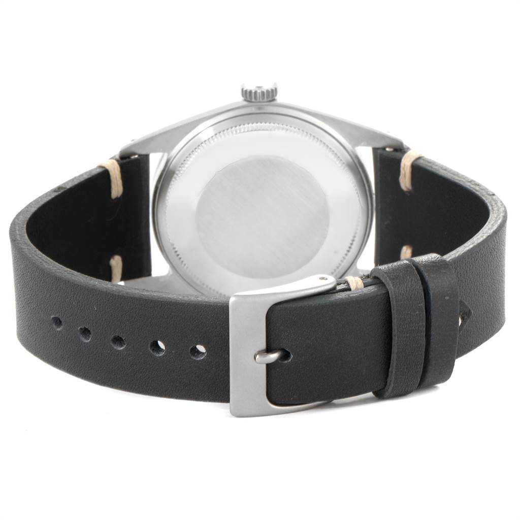 The image shows the back view of a Vintage Collection Rolex watch with a black leather strap and stainless steel buckle.