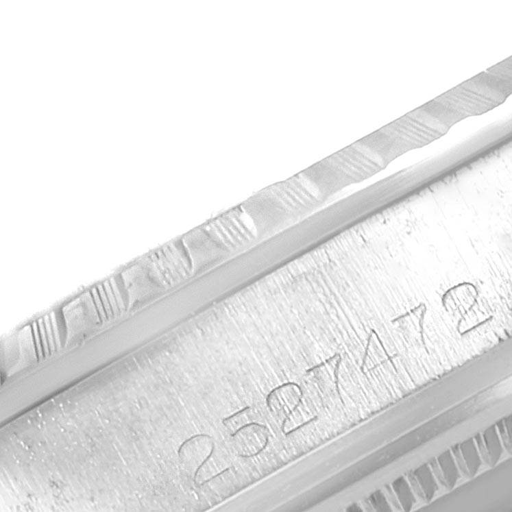 The image shows a close-up of the serial number engraving on the case side of a Vintage Collection Rolex watch.