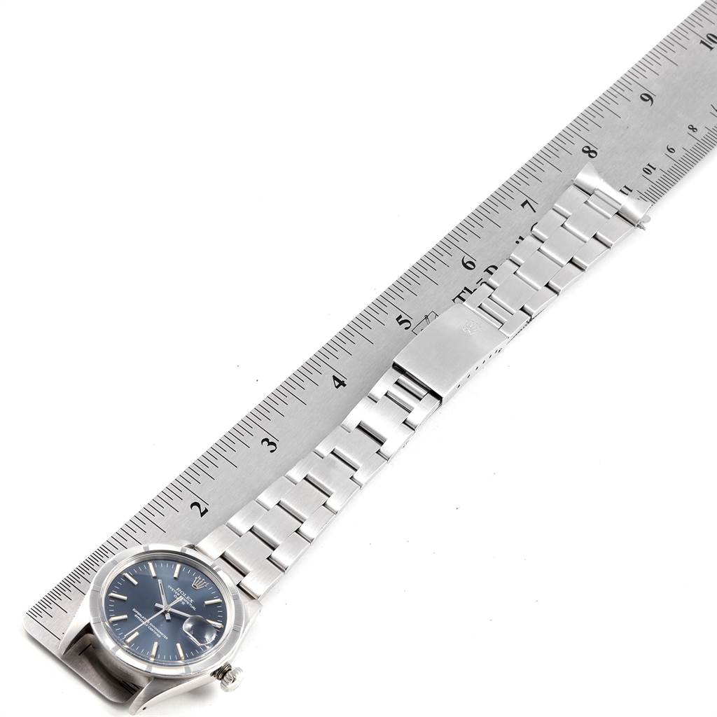 The image shows a Rolex Vintage Collection 1501 Men's Stainless Steel Blue Dial 1501 Men's Stainless Steel Blue Dial watch laid against a ruler, displaying the watch face and bracelet.