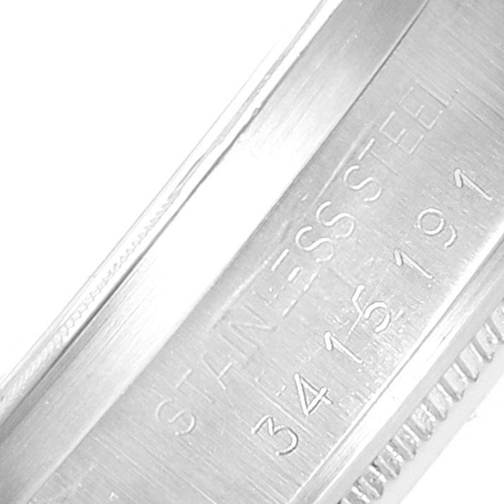 The image shows a close-up view of the stainless steel band of a Rolex Vintage Collection 1501 Men's Stainless Steel Blue Dial 1501 Men's Stainless Steel Blue Dial watch, featuring serial number details.