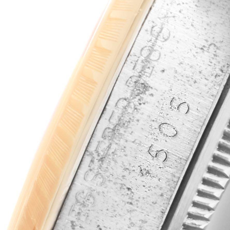 This image shows a close-up of the side case of a Rolex Vintage Collection 1505 Men's Steel and Gold (two tone) Silver Dial 1505 Men's Steel and Gold (two tone) Silver Dial watch, highlighting the serial engraving and parts of the bezel.