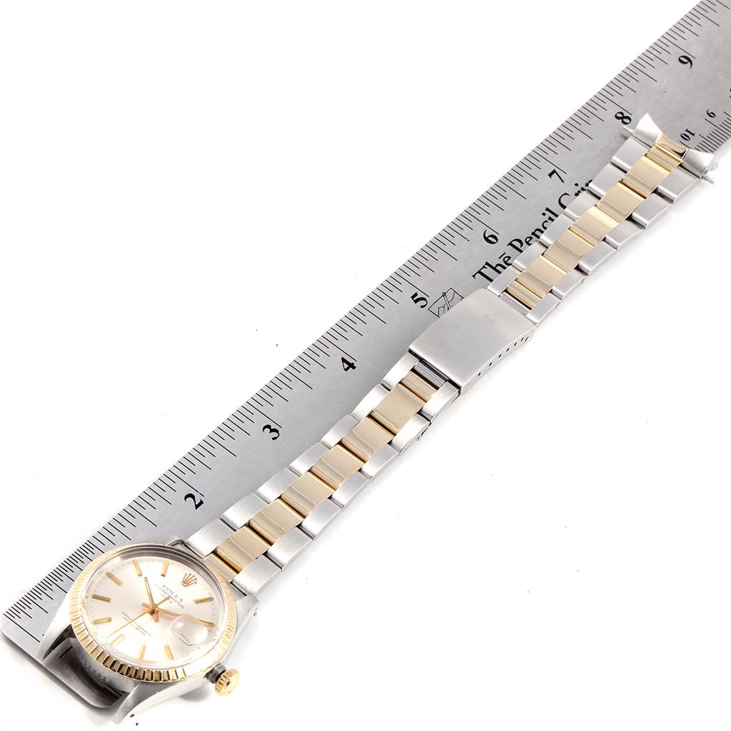 The image shows a side angle of the Rolex Vintage Collection 1505 Men's Steel and Gold (two tone) Silver Dial 1505 Men's Steel and Gold (two tone) Silver Dial watch, highlighting the face, bezel, crown, and bracelet, alongside a ruler.