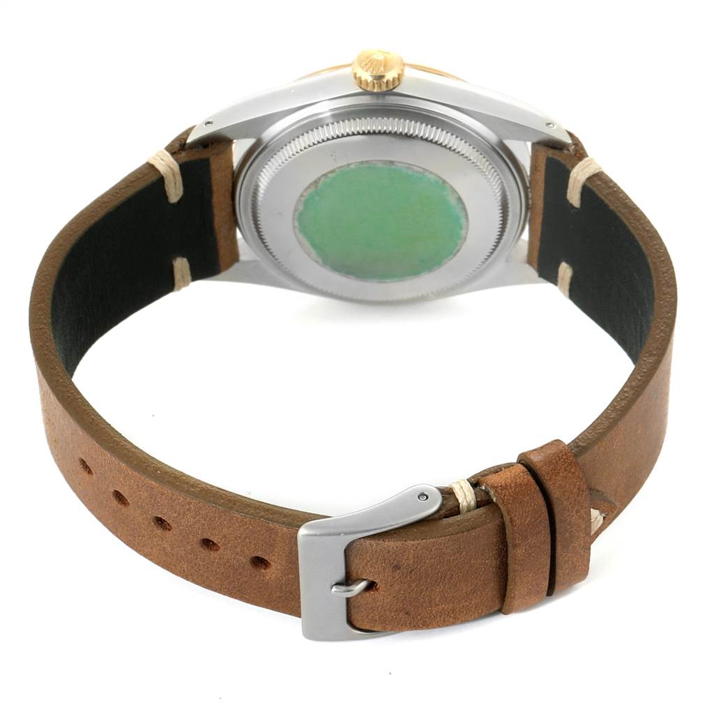 The image shows the back and crown of the Rolex Vintage Collection 16013 Men's Stainless Steel Champagne Dial 16013 Men's Stainless Steel Champagne Dial watch with a brown leather strap.