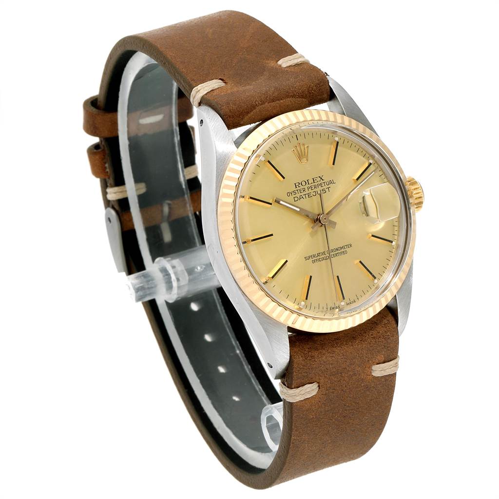 The image shows a side-angle view of a Rolex Vintage Collection 16013 Men's Stainless Steel Champagne Dial 16013 Men's Stainless Steel Champagne Dial watch, highlighting the face, bezel, and leather strap.