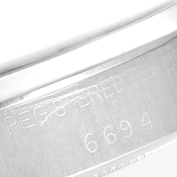 This image shows the engraved model number "6694" on the case of a Rolex Vintage Collection 6694 Men's Stainless Steel Champagne Dial 6694 Men's Stainless Steel Champagne Dial watch.