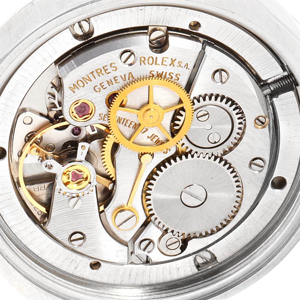 The image shows a close-up of the internal mechanics of the Vintage Collection model by Rolex, highlighting gears and jewel bearings.
