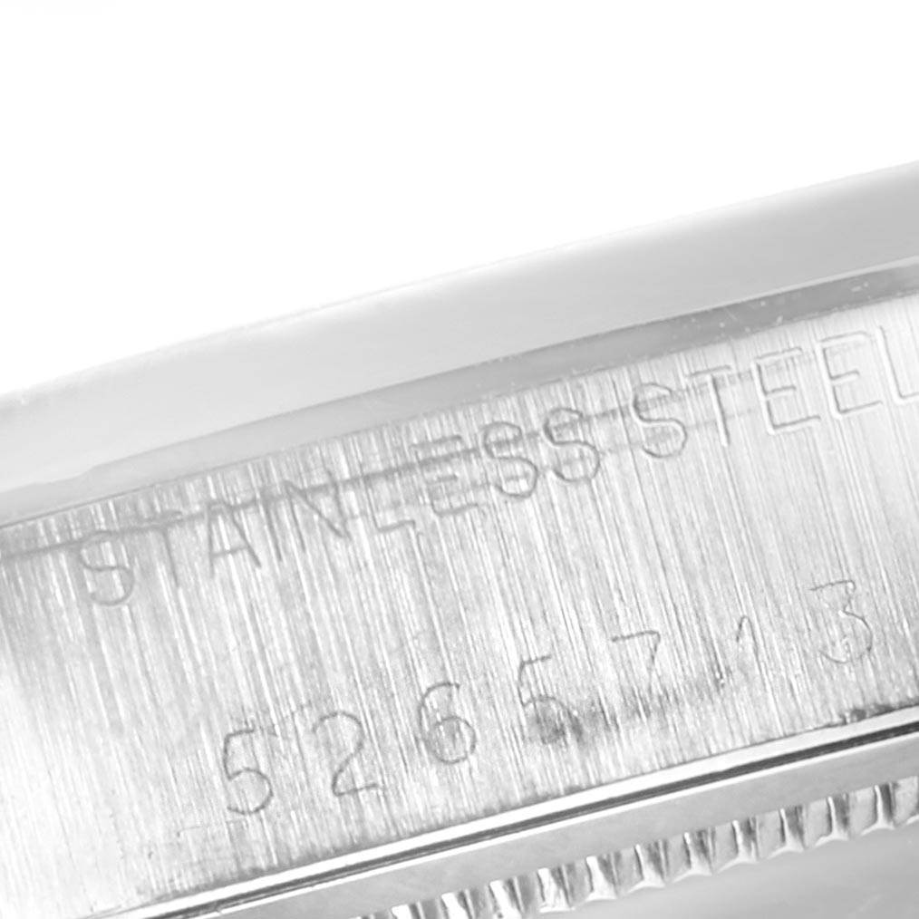 The image shows a close-up of the engraved stainless steel part of a Rolex Vintage Collection 6694 Men's Stainless Steel Champagne Dial 6694 Men's Stainless Steel Champagne Dial model watch.