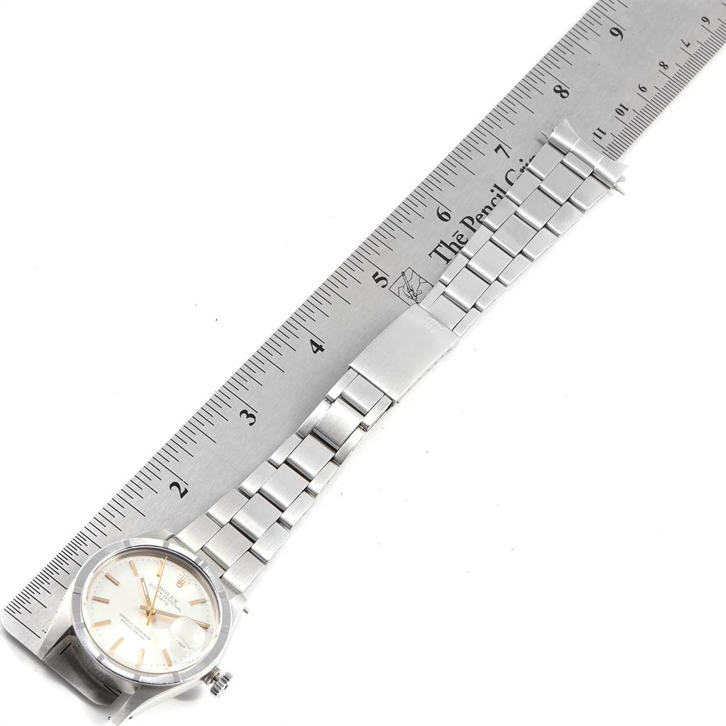 The image shows a Rolex Vintage Collection 1501 Men's Stainless Steel Silver Dial 1501 Men's Stainless Steel Silver Dial watch laid flat with a ruler measuring its metal bracelet.