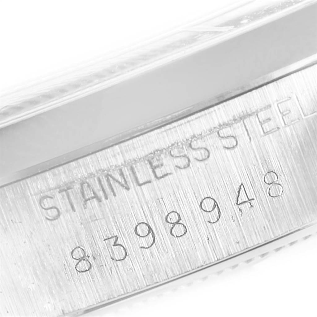 This close-up image shows the serial number and "Stainless Steel" engraving on the casing of a Rolex Vintage Collection 6694 Men's Stainless Steel Silver Dial 6694 Men's Stainless Steel Silver Dial watch.